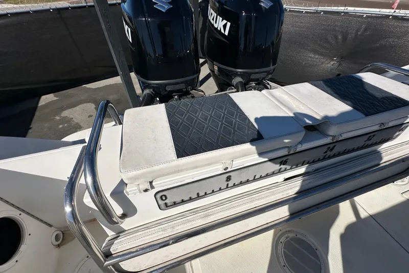 Slide: The Image of 1999 Robalo 2420 Center Console boat with Suzuki engines and cushioned seating. - 48