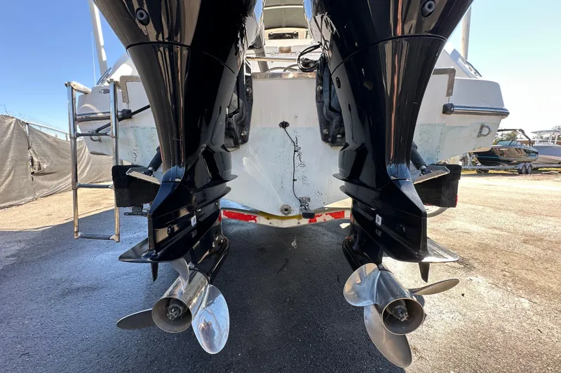 Slide: The Image of 1999 Robalo 2420 Center Console boat with dual outboard motors, rear view. - 5