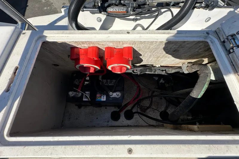 Slide: The Image of 1999 Robalo 2420 Center Console battery compartment with wiring and switches. - 50