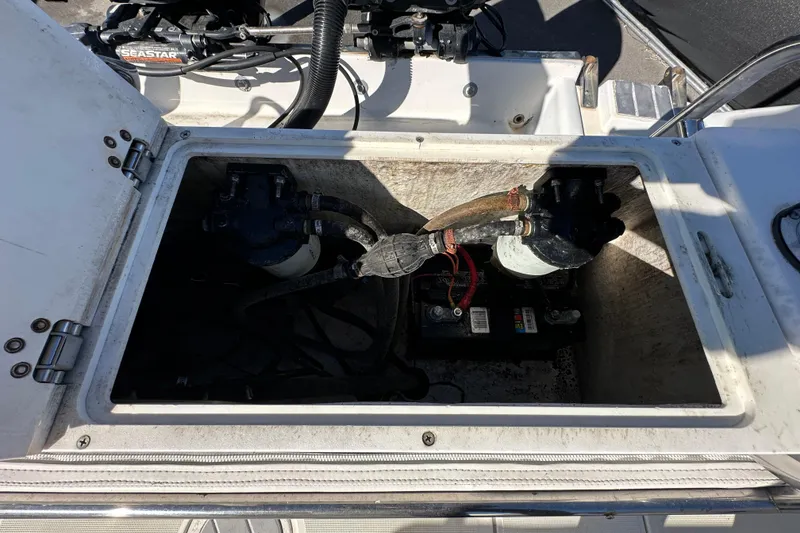Slide: The Image of 1999 Robalo 2420 Center Console boat battery compartment with wiring and components. - 53