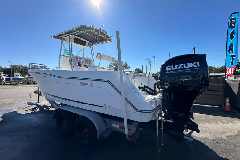 Slide: The Image of 1999 Robalo 2420 Center Console boat with Suzuki outboard motor on trailer. - 6