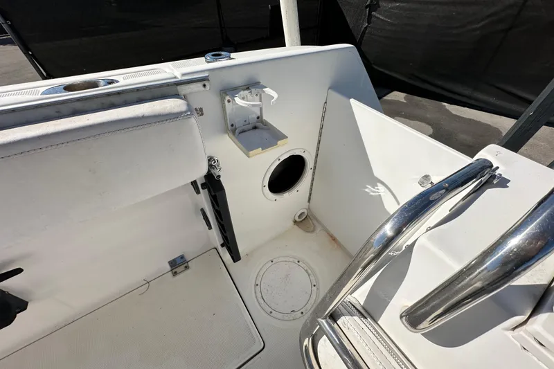 Slide: The Image of 1999 Robalo 2420 Center Console boat interior with seating and storage compartments. - 63