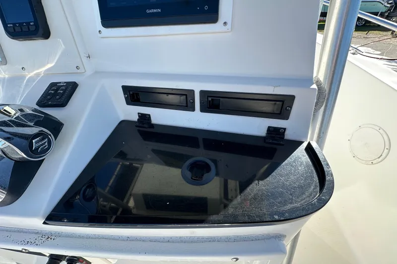 Slide: The Image of 1999 Robalo 2420 Center Console dashboard with Garmin display and controls. - 64