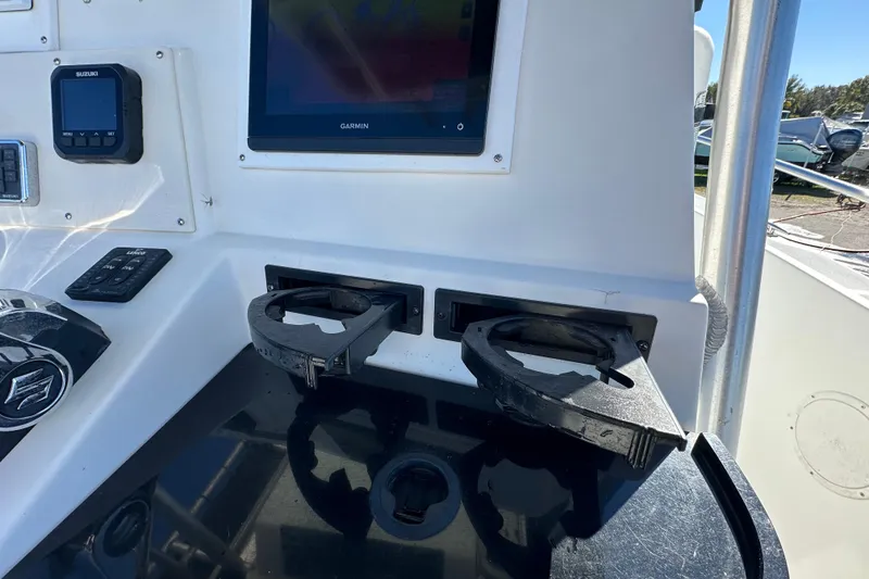 Slide: The Image of 1999 Robalo 2420 Center Console dashboard with Garmin display and cup holders. - 65