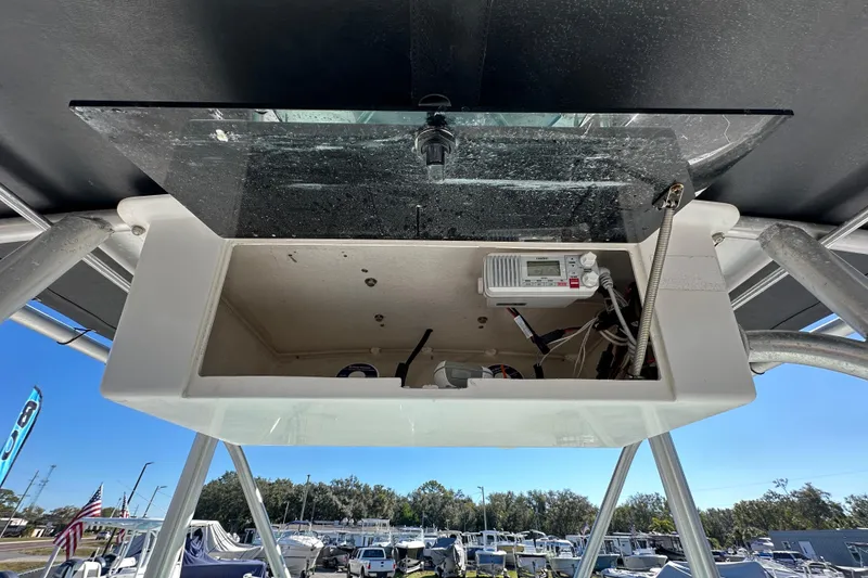 Slide: The Image of 1999 Robalo 2420 Center Console electronics compartment with wiring and equipment. - 68