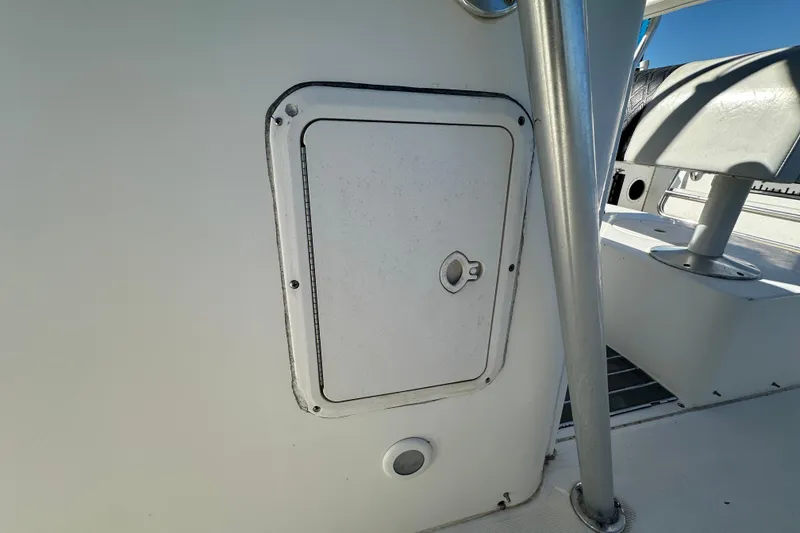 Slide: The Image of 1999 Robalo 2420 Center Console boat interior with storage compartment and seating. - 69
