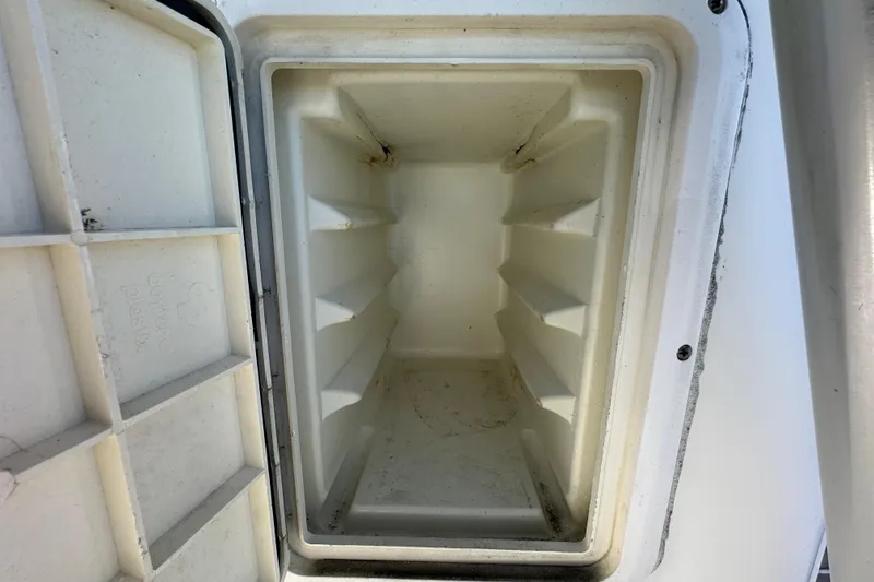 Slide: The Image of Open storage compartment on a 1999 Robalo 2420 Center Console boat. - 71