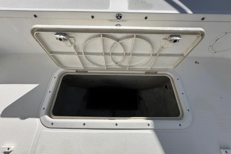 Slide: The Image of Open storage compartment on 1999 Robalo 2420 Center Console boat. - 73