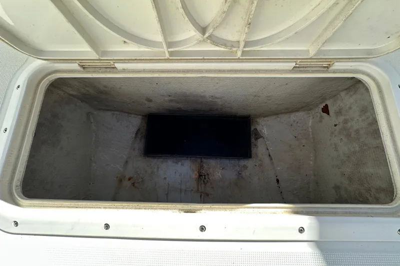Slide: The Image of Open storage compartment on 1999 Robalo 2420 Center Console boat. - 74