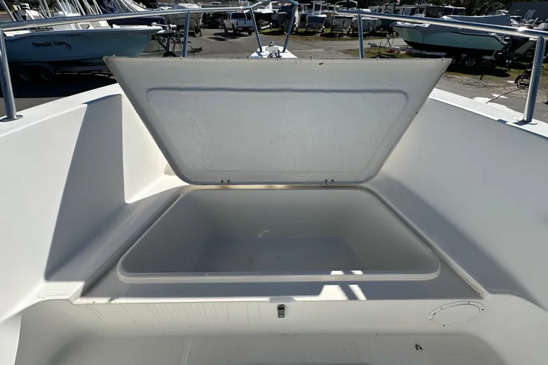 Slide: The Image of Open storage compartment on a 1999 Robalo 2420 Center Console boat. - 76