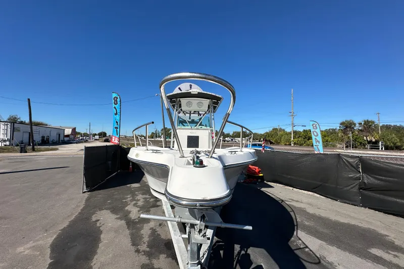 Slide: The Image of 1999 Robalo 2420 Center Console boat on trailer under clear blue sky. - 9