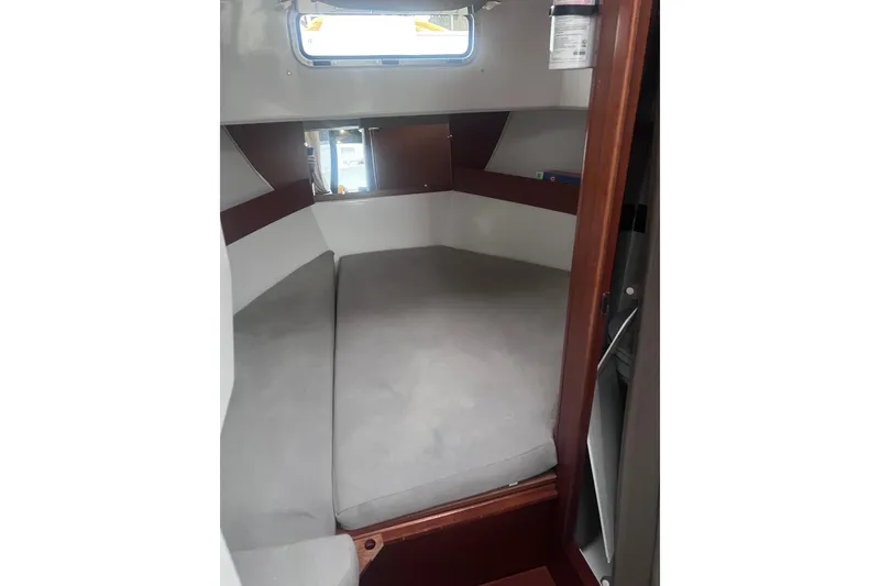Slide: The Image of 2015 Jeanneau Merry Fisher 855 Marlin cabin interior with cushioned seating. - 10