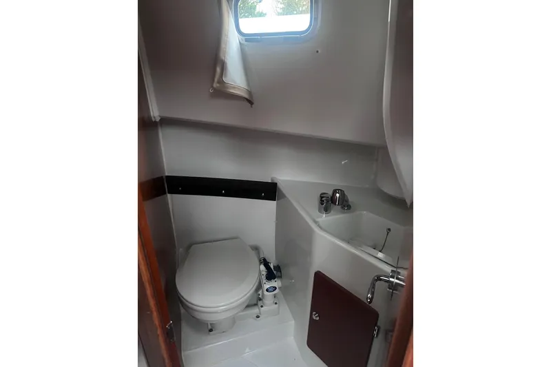 Slide: The Image of Bathroom interior of 2015 Jeanneau Merry Fisher 855 Marlin boat, featuring toilet and sink. - 11