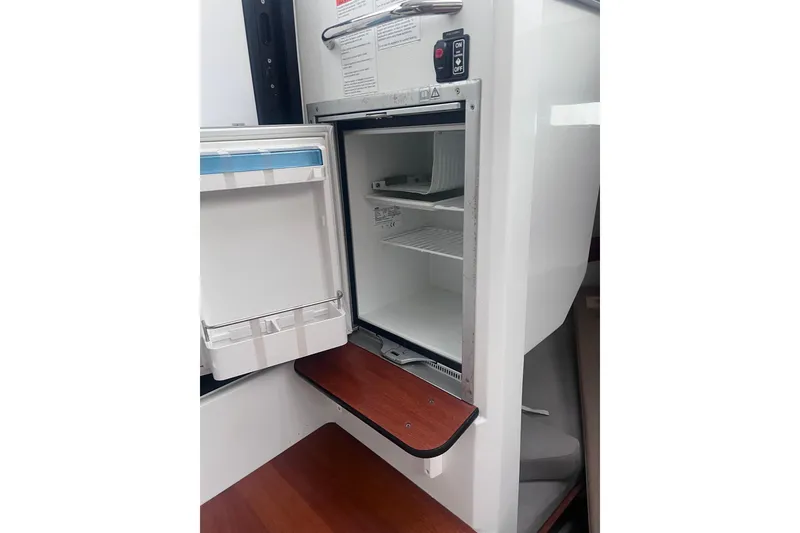 Slide: The Image of Open refrigerator inside 2015 Jeanneau Merry Fisher 855 Marlin boat cabin. - 13