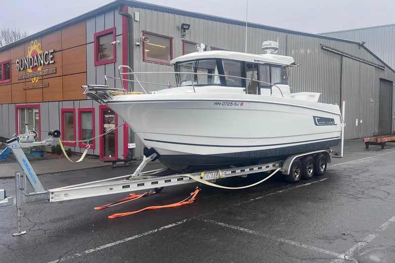 Slide: The Image of 2015 Jeanneau Merry Fisher 855 Marlin boat on trailer outside Sundance boat sales. - 2