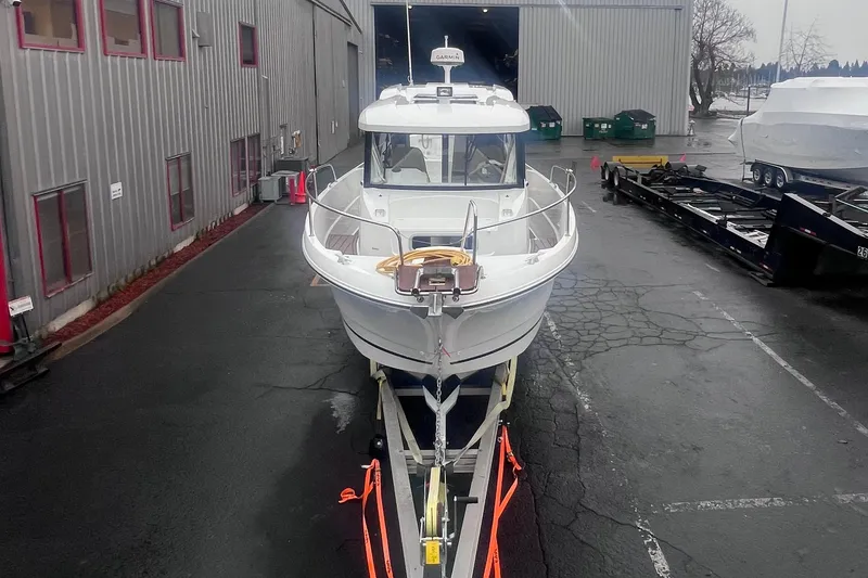 Slide: The Image of 2015 Jeanneau Merry Fisher 855 Marlin on trailer outside industrial building. - 4