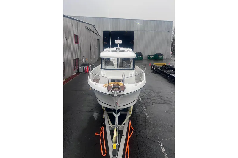 Slide: The Image of 2015 Jeanneau Merry Fisher 855 Marlin boat on trailer outside warehouse. - 5