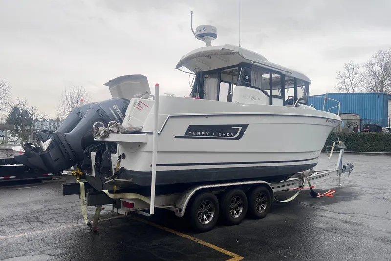 Slide: The Image of 2015 Jeanneau Merry Fisher 855 Marlin on trailer, featuring Yamaha outboard motor. - 7
