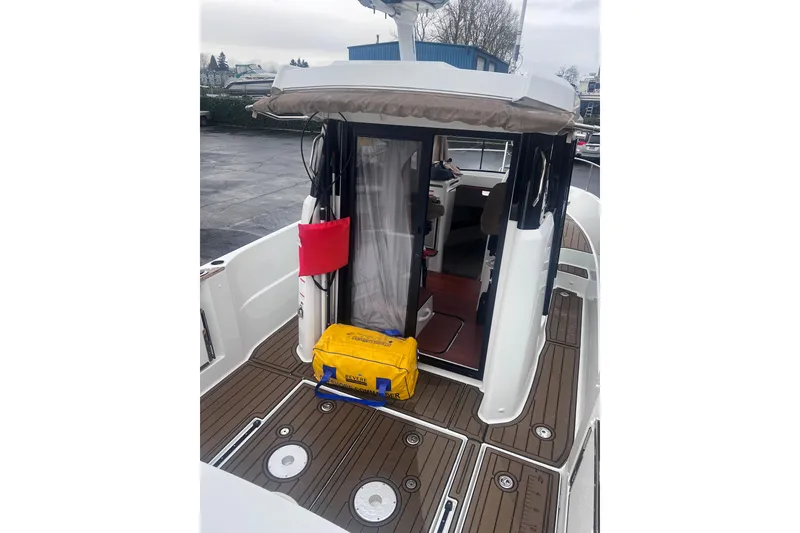 Slide: The Image of 2015 Jeanneau Merry Fisher 855 Marlin boat deck with open cabin door. - 8