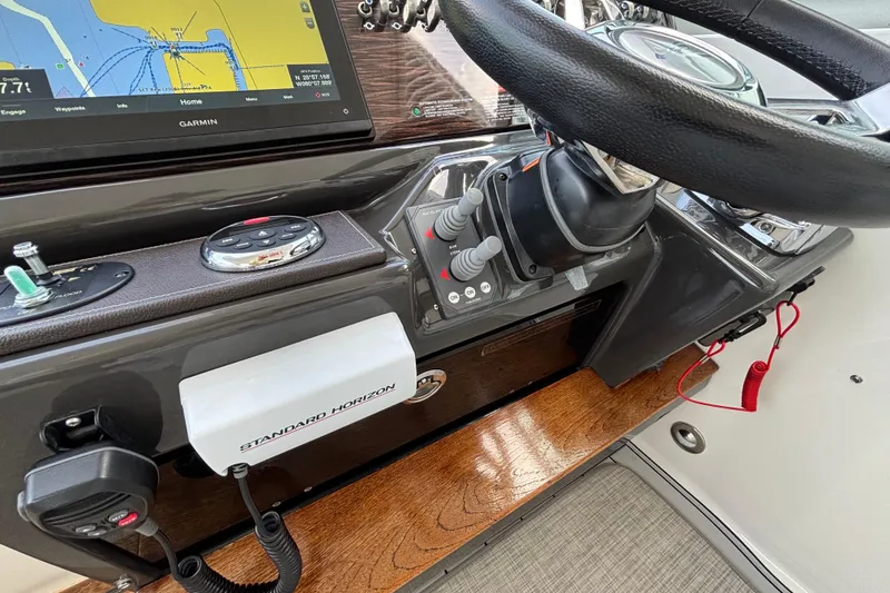 Slide: The Image of Helm of 2016 Sea Ray 350 Sundancer with Garmin navigation and Standard Horizon equipment. - 13