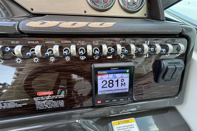 Slide: The Image of Control panel of 2016 Sea Ray 350 Sundancer with switches and Garmin display. - 14