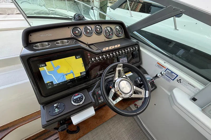 Slide: The Image of Cockpit of 2016 Sea Ray 350 Sundancer with navigation display and steering wheel. - 15