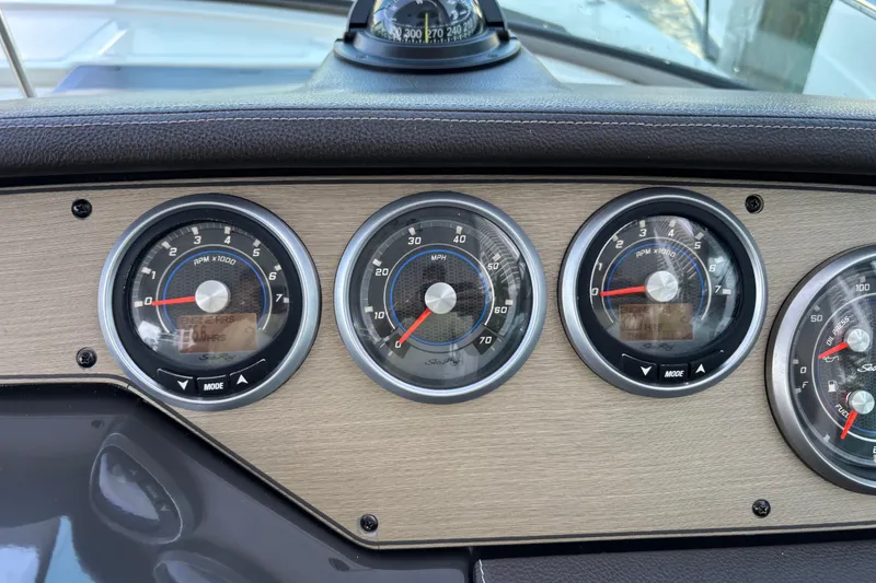 Slide: The Image of Dashboard of a 2016 Sea Ray 350 Sundancer boat with gauges and compass. - 16