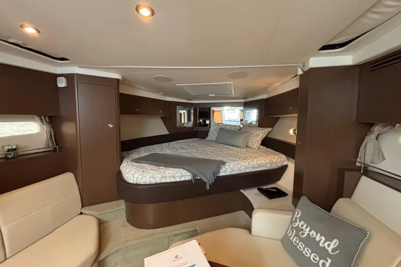 Slide: The Image of Luxurious interior of 2016 Sea Ray 350 Sundancer yacht with cozy bed and seating area. - 17