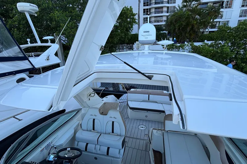 Slide: The Image of 2016 Sea Ray 350 Sundancer yacht with open sunroof and luxurious seating. - 23