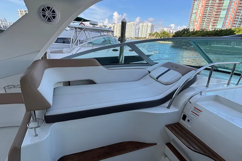 Slide: The Image of 2016 Sea Ray 350 Sundancer boat interior with luxurious seating and waterfront view. - 25