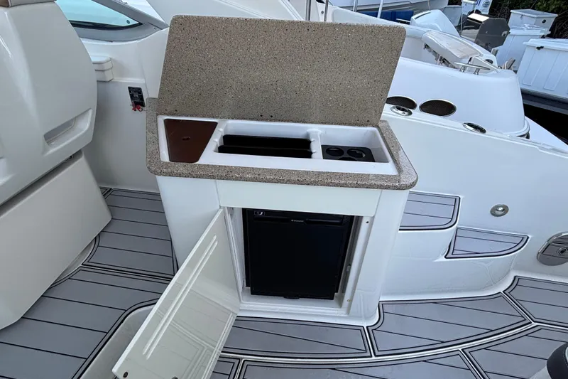 Slide: The Image of 2016 Sea Ray 350 Sundancer boat kitchenette with sink and mini fridge. - 28