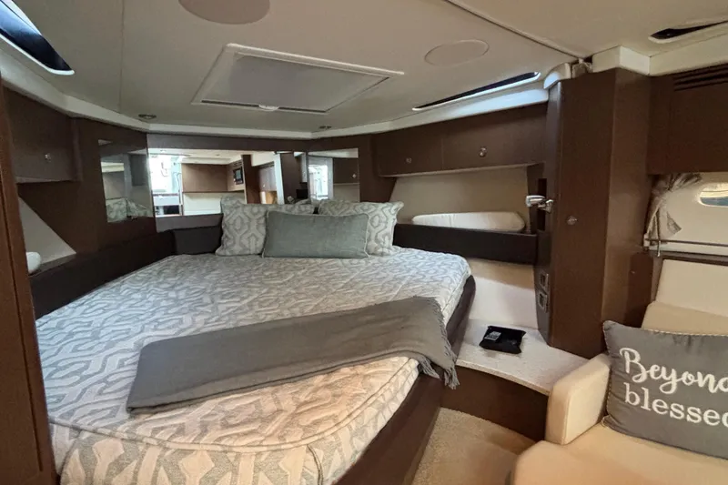 Slide: The Image of Luxurious interior of 2016 Sea Ray 350 Sundancer yacht with cozy bedding and elegant decor. - 29