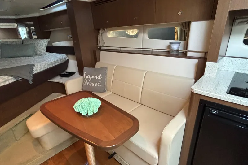 Slide: The Image of Interior of 2016 Sea Ray 350 Sundancer with cozy seating and modern amenities. - 32