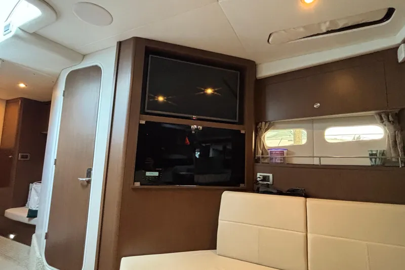 Slide: The Image of Interior of 2016 Sea Ray 350 Sundancer yacht with TV and seating area. - 34