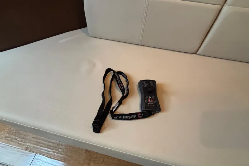 Slide: The Image of Remote control with lanyard on a Sea Ray 350 Sundancer 2016 boat seat. - 35