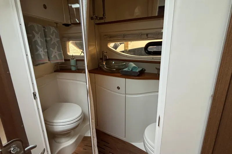 Slide: The Image of 2016 Sea Ray 350 Sundancer bathroom with modern fixtures and starfish-themed decor. - 36