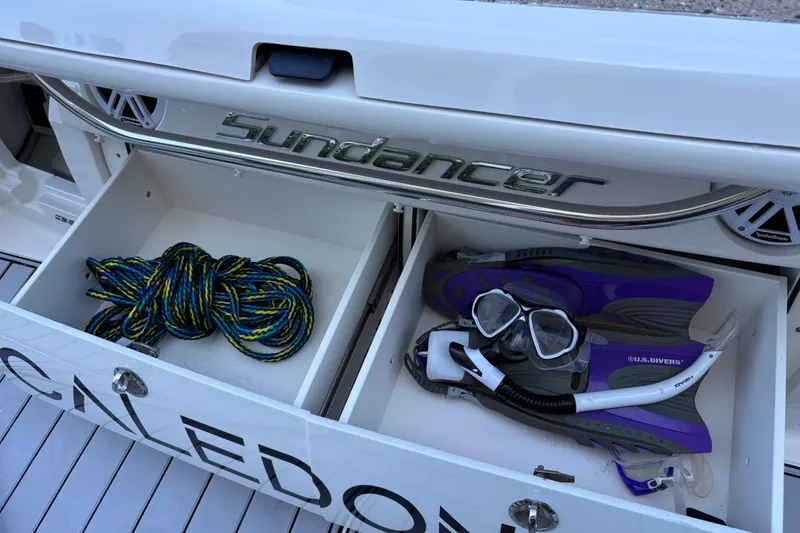 Slide: The Image of Storage compartments on a 2016 Sea Ray 350 Sundancer with rope and snorkeling gear. - 41