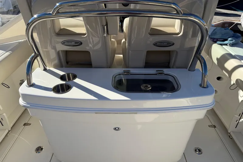 Slide: The Image of 2025 Boston Whaler 250 Outrage dashboard with Garmin navigation and controls. - 28
