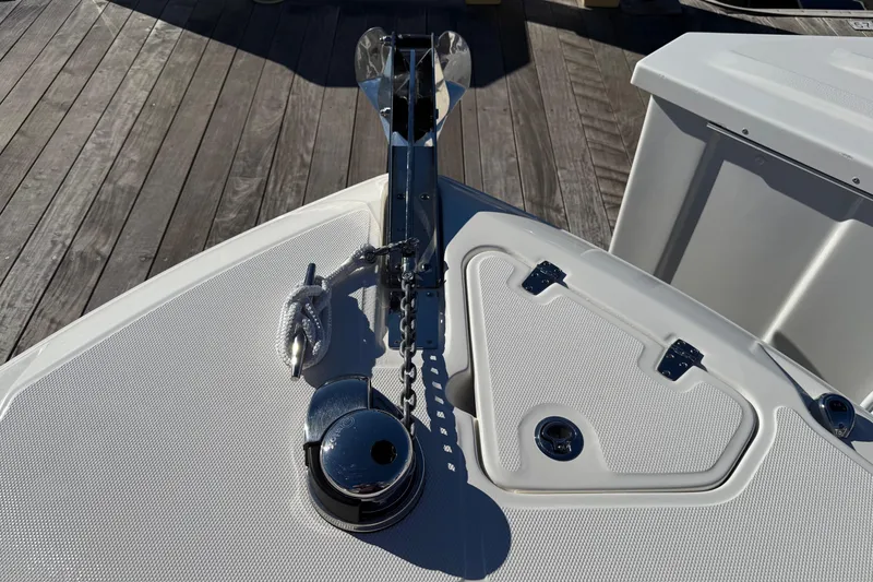 Slide: The Image of Anchor storage compartment on 2025 Boston Whaler 250 Outrage boat, featuring ropes and equipment. - 45