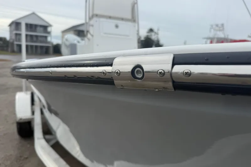 Slide: The Image of 2026 Lookout Bay 19 boat with sleek chrome detailing and modern design. - 13