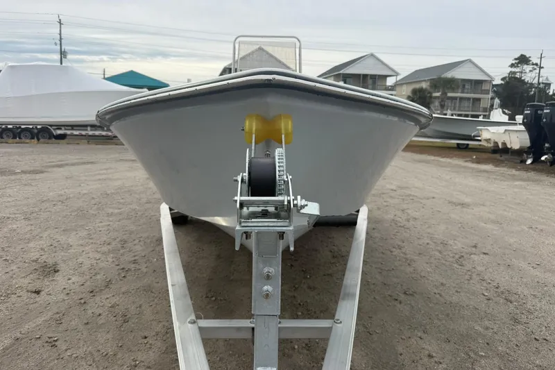 Slide: The Image of 2026 Lookout Bay 19 boat on trailer, parked outdoors near buildings. - 16