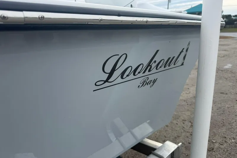 Slide: The Image of Side view of a 2026 Lookout Bay 19 boat with logo. - 3