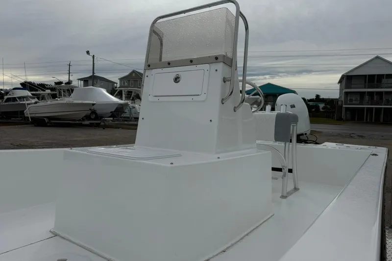 Slide: The Image of 2026 Lookout Bay 19 boat with sleek white design, docked in a marina setting. - 5