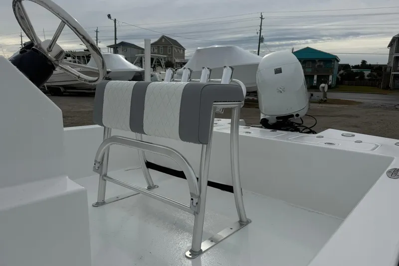 Slide: The Image of 2026 Lookout Bay 19 boat interior with steering wheel and seating. - 6
