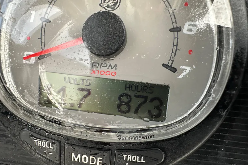 Slide: The Image of 2016 Boston Whaler 210 Dauntless boat interior with steering console and seating area. - 16