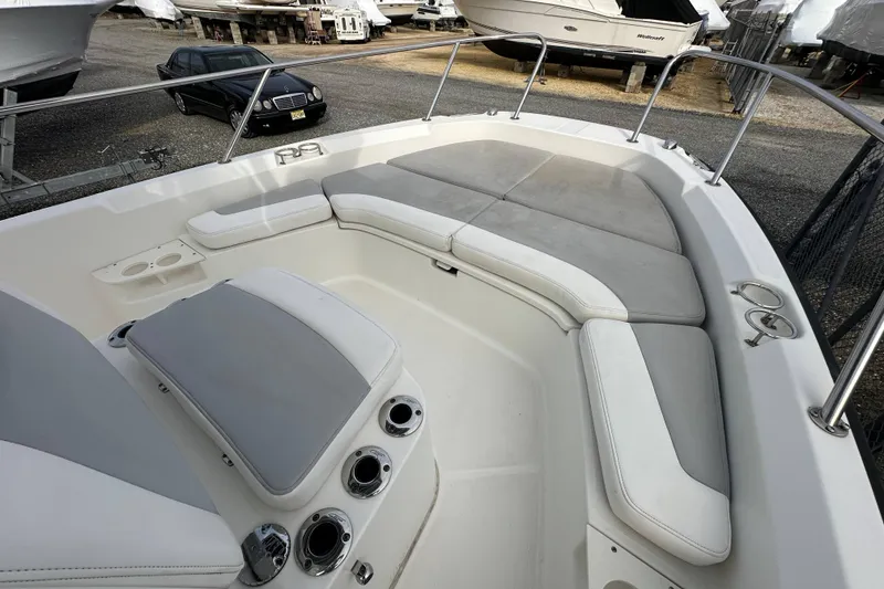 Slide: The Image of 2016 Boston Whaler 210 Dauntless boat with Mercury engine, parked in a marina. - 19