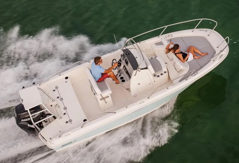 Slide: The Image of 2016 Boston Whaler 210 Dauntless boat interior with seating and storage compartments. - 6