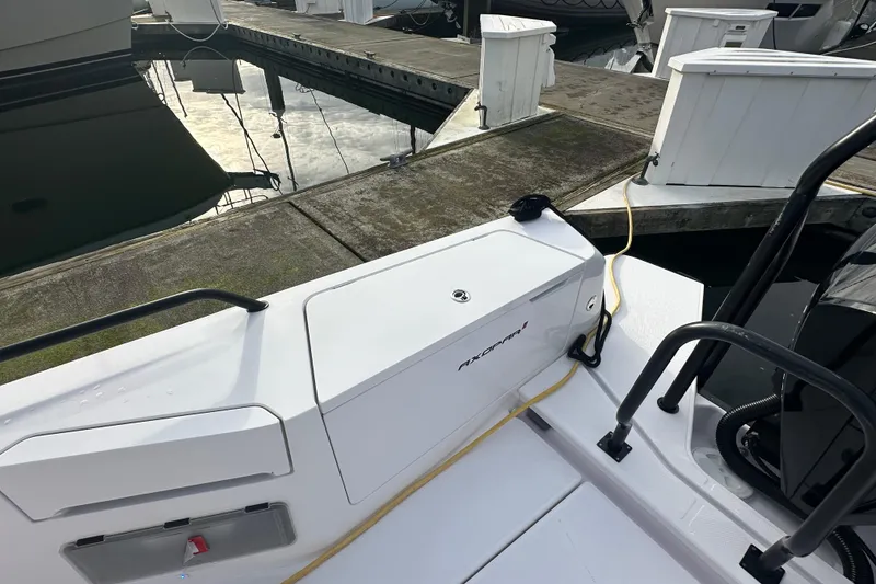 Slide: The Image of 2022 Axopar 37 XC Cross Cabin docked at marina, showcasing sleek design and modern features. - 13