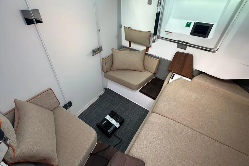 Slide: The Image of Interior of 2022 Axopar 37 XC Cross Cabin with beige seating and modern design. - 15