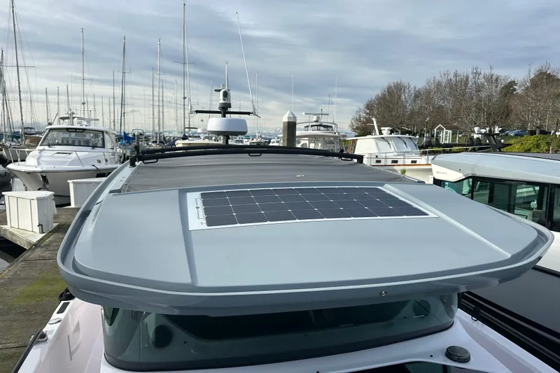 Slide: The Image of 2022 Axopar 37 XC Cross Cabin with solar panel, docked at marina. - 24